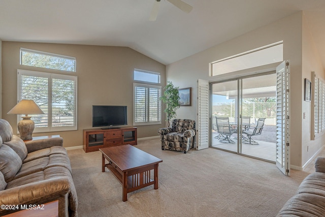 carpeted living room with ceiling fan and lofted ceiling