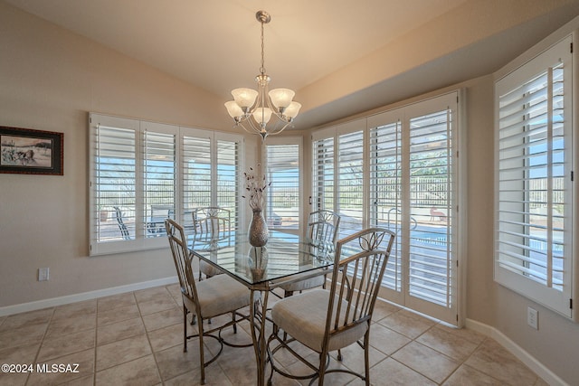 unfurnished dining area with a notable chandelier, light tile patterned floors, and vaulted ceiling