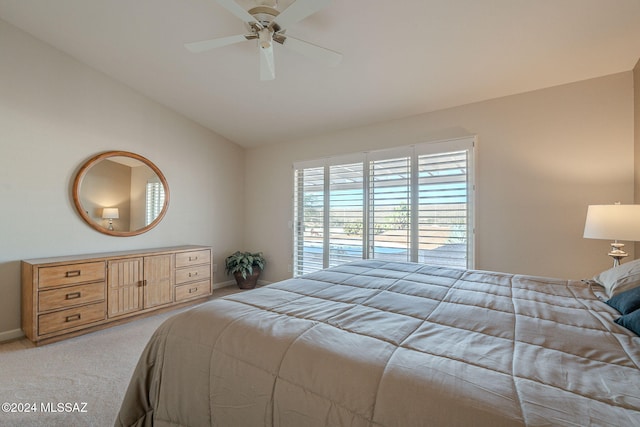 carpeted bedroom featuring ceiling fan and vaulted ceiling