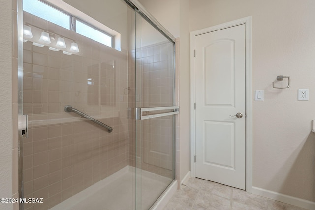 bathroom featuring tile patterned floors and a shower with door