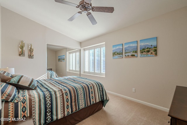 bedroom with ceiling fan, a closet, carpet floors, and lofted ceiling