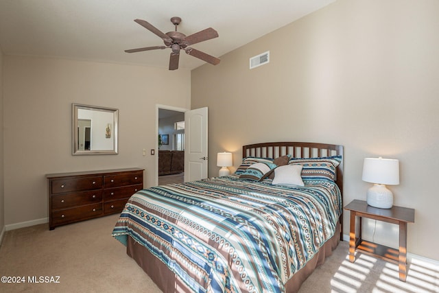 carpeted bedroom with vaulted ceiling and ceiling fan