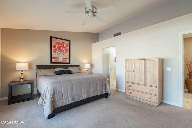 bedroom with ceiling fan, light colored carpet, and lofted ceiling