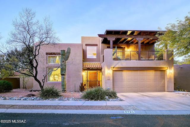 view of front facade with a balcony and a garage