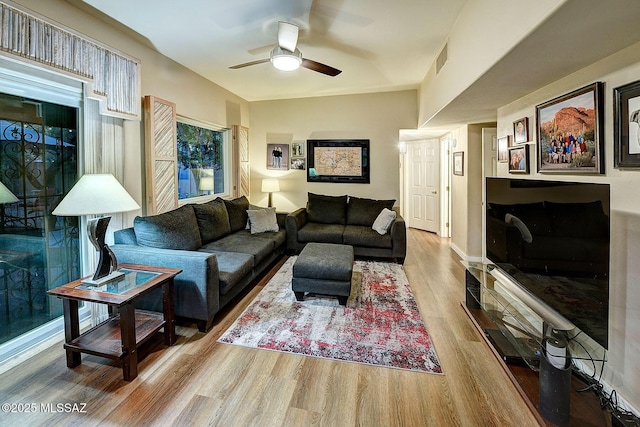 living room with hardwood / wood-style flooring and ceiling fan