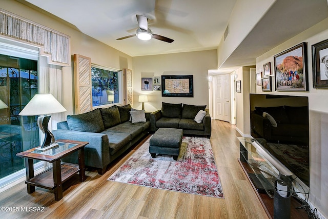 living room with light hardwood / wood-style flooring and ceiling fan