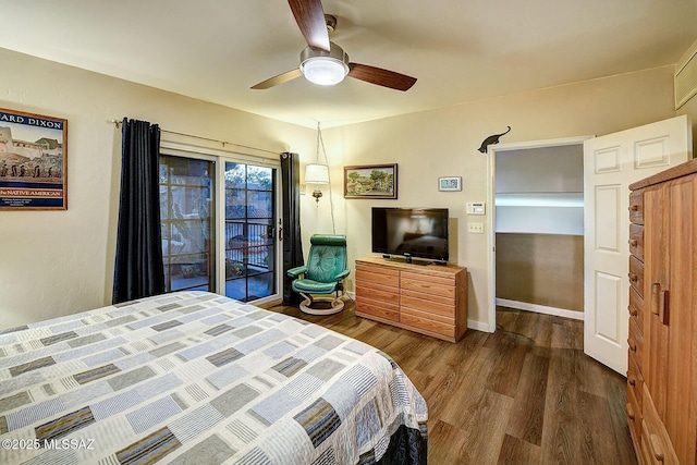 bedroom featuring access to outside, ceiling fan, and dark hardwood / wood-style flooring