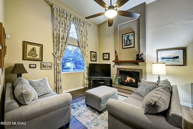 living room featuring hardwood / wood-style flooring, ceiling fan, and lofted ceiling