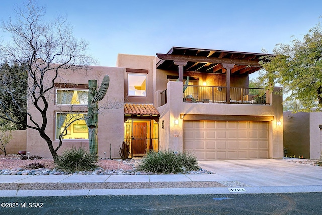 view of front of house featuring a balcony and a garage