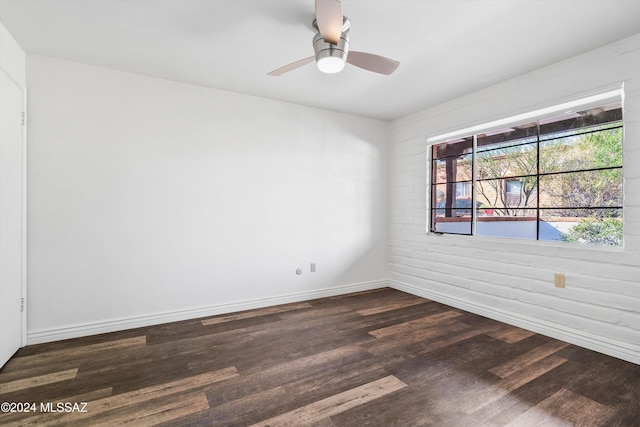 spare room with ceiling fan and dark wood-type flooring