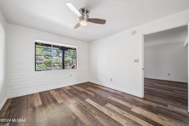 unfurnished room with dark hardwood / wood-style flooring and ceiling fan