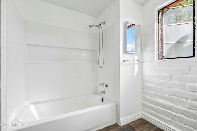 bathroom with wood-type flooring and  shower combination