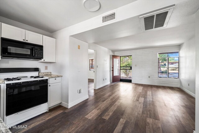 kitchen featuring white range with gas cooktop, white cabinetry, and dark hardwood / wood-style flooring