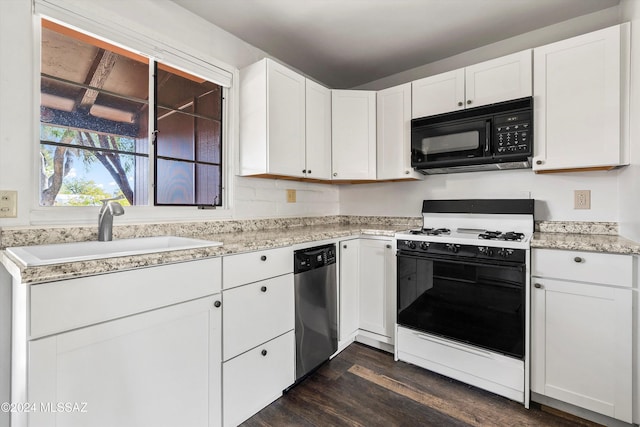 kitchen with white cabinets, white gas stove, and sink