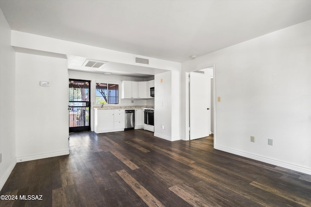 unfurnished living room with dark hardwood / wood-style floors and sink