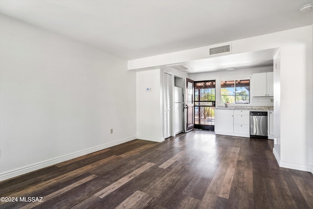 kitchen featuring light stone countertops, refrigerator, stainless steel dishwasher, white cabinets, and dark hardwood / wood-style floors