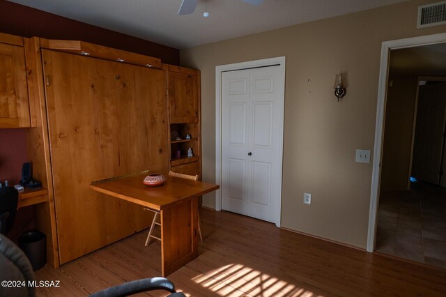 home office featuring ceiling fan and light hardwood / wood-style flooring