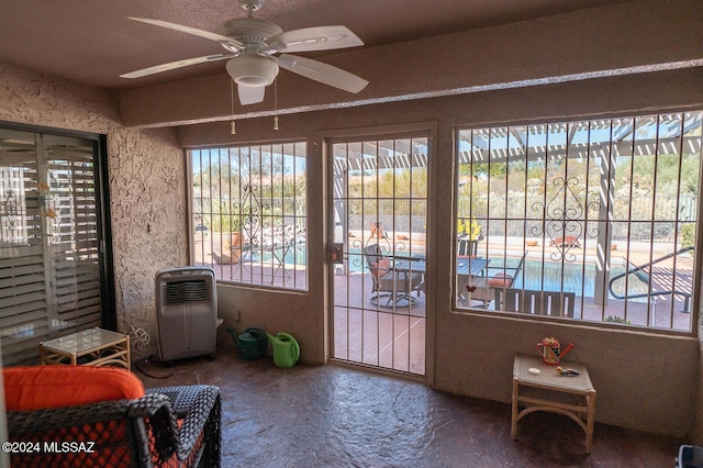 sunroom with ceiling fan