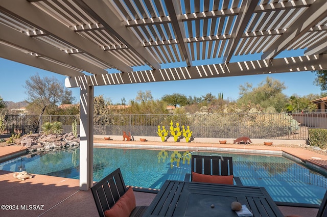 view of pool with a pergola and a patio