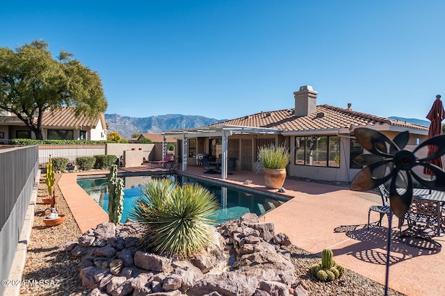 view of pool featuring a mountain view and a patio