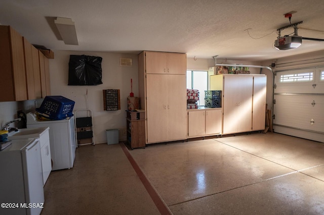 garage featuring washer / clothes dryer, sink, and a garage door opener