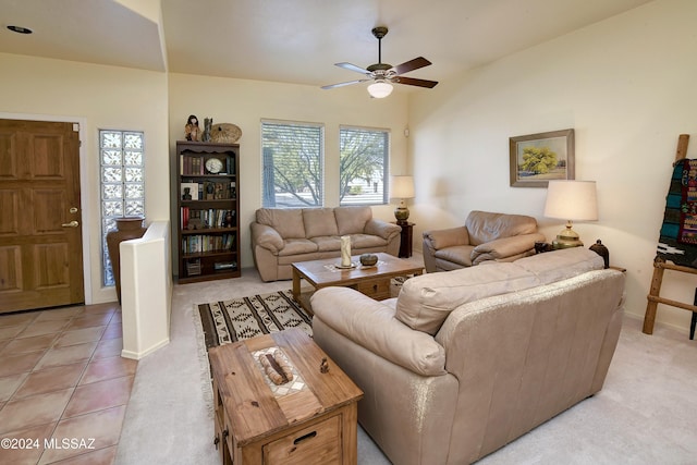 living room featuring ceiling fan, light tile patterned flooring, and lofted ceiling