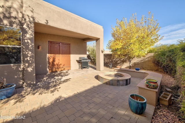 view of patio / terrace featuring a fire pit and a grill