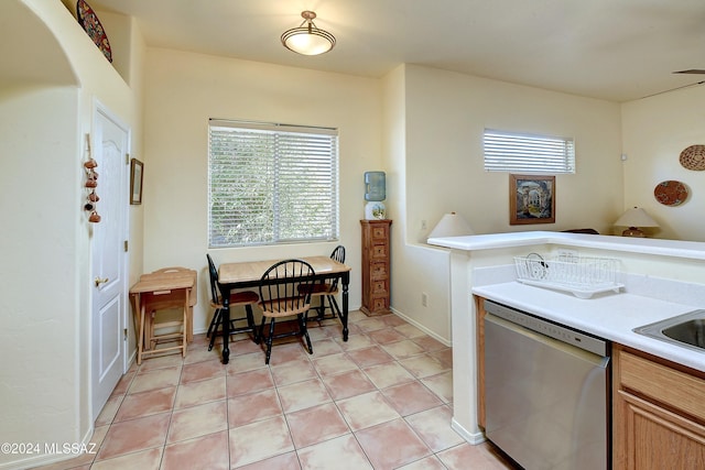 kitchen featuring stainless steel dishwasher and light tile patterned flooring