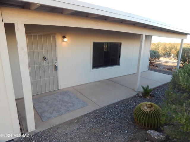 view of exterior entry featuring a patio