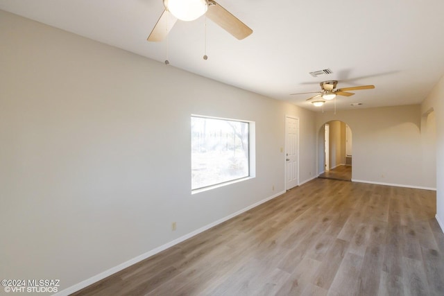 spare room featuring ceiling fan and light hardwood / wood-style flooring