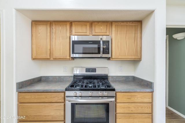 kitchen featuring light brown cabinetry and stainless steel appliances