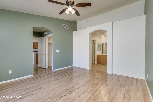 empty room with ceiling fan and light wood-type flooring