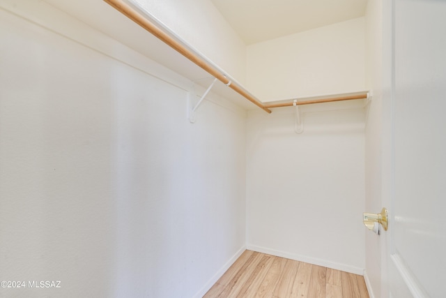 walk in closet with light wood-type flooring