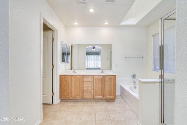 bathroom with tile patterned flooring, vanity, ceiling fan, and plus walk in shower