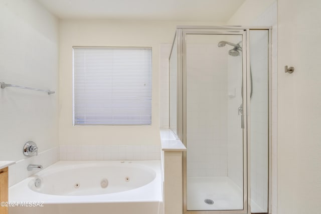 bathroom featuring separate shower and tub