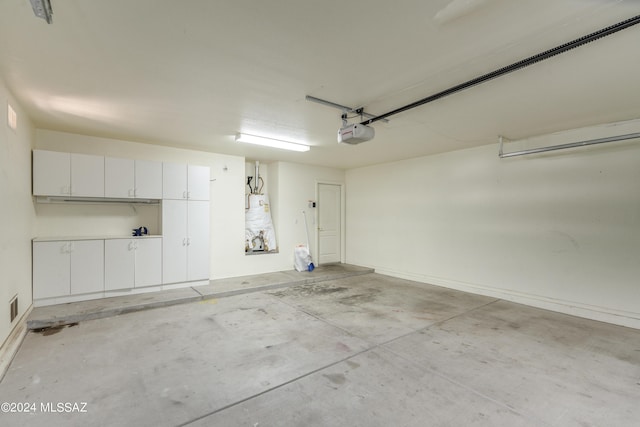 garage with strapped water heater and a garage door opener