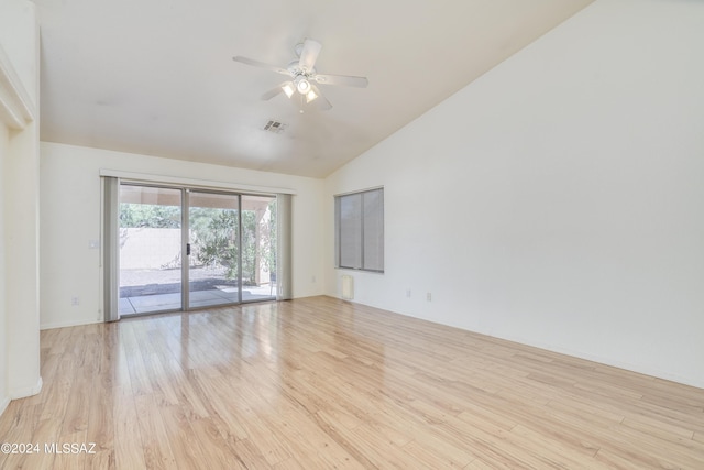 empty room featuring ceiling fan, lofted ceiling, and light hardwood / wood-style flooring