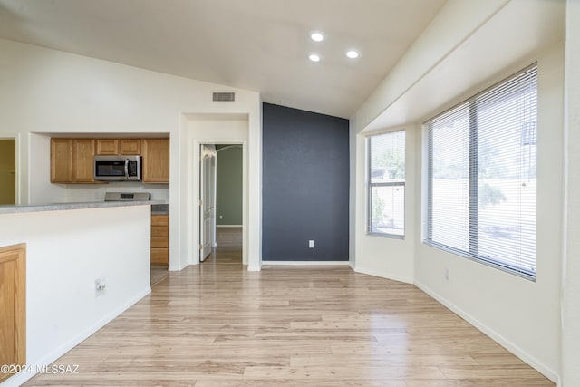 kitchen featuring vaulted ceiling and light wood-type flooring