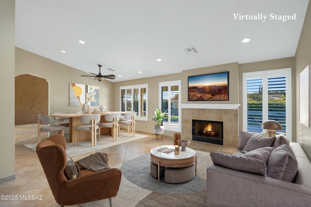 unfurnished living room featuring a tiled fireplace, a ceiling fan, recessed lighting, and light tile patterned flooring