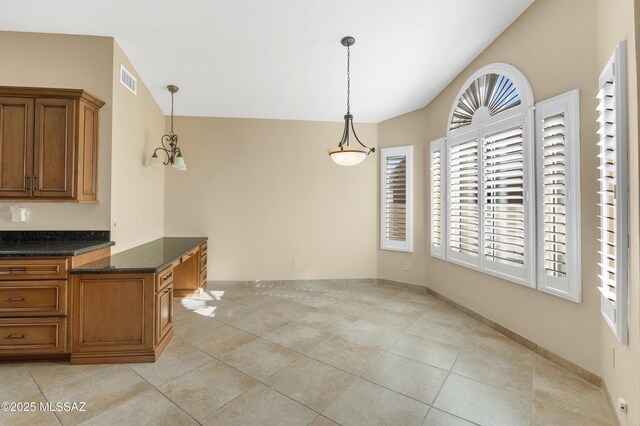 kitchen with black range with gas stovetop, dark countertops, stainless steel microwave, a chandelier, and open floor plan