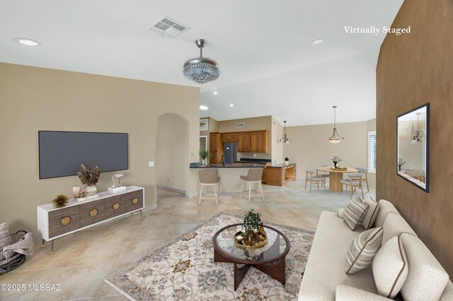 empty room with arched walkways, visible vents, a ceiling fan, and recessed lighting
