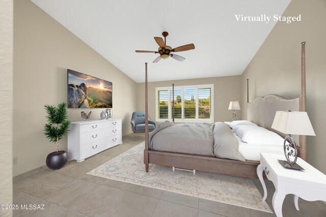 bedroom with lofted ceiling, a ceiling fan, baseboards, and light tile patterned flooring