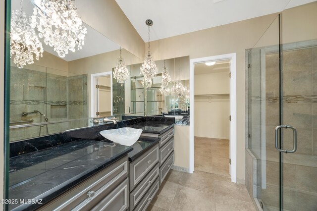 bathroom featuring tile patterned floors, vanity, a notable chandelier, and a stall shower