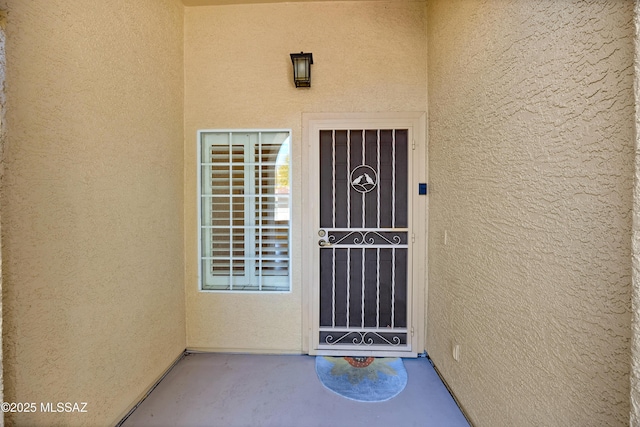 property entrance with stucco siding