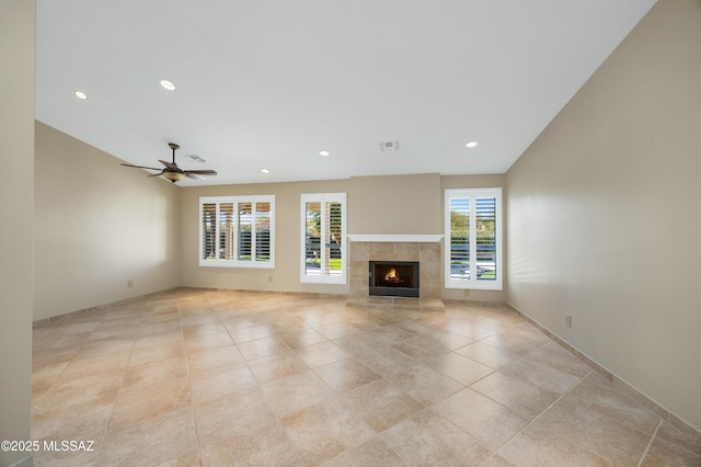 unfurnished living room with ceiling fan, recessed lighting, visible vents, and a tiled fireplace