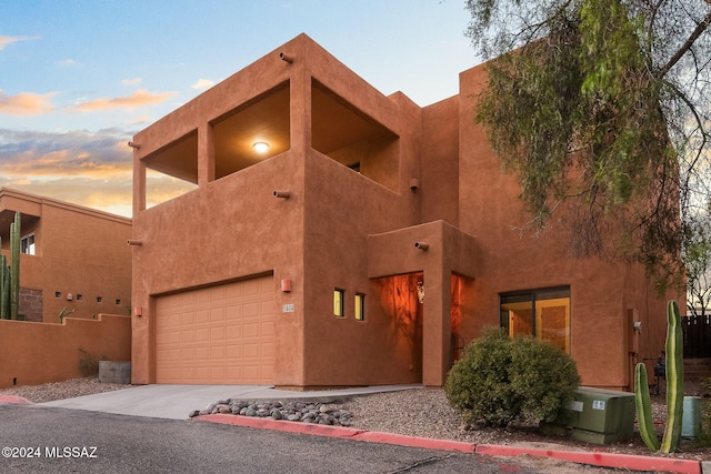 adobe home featuring a garage