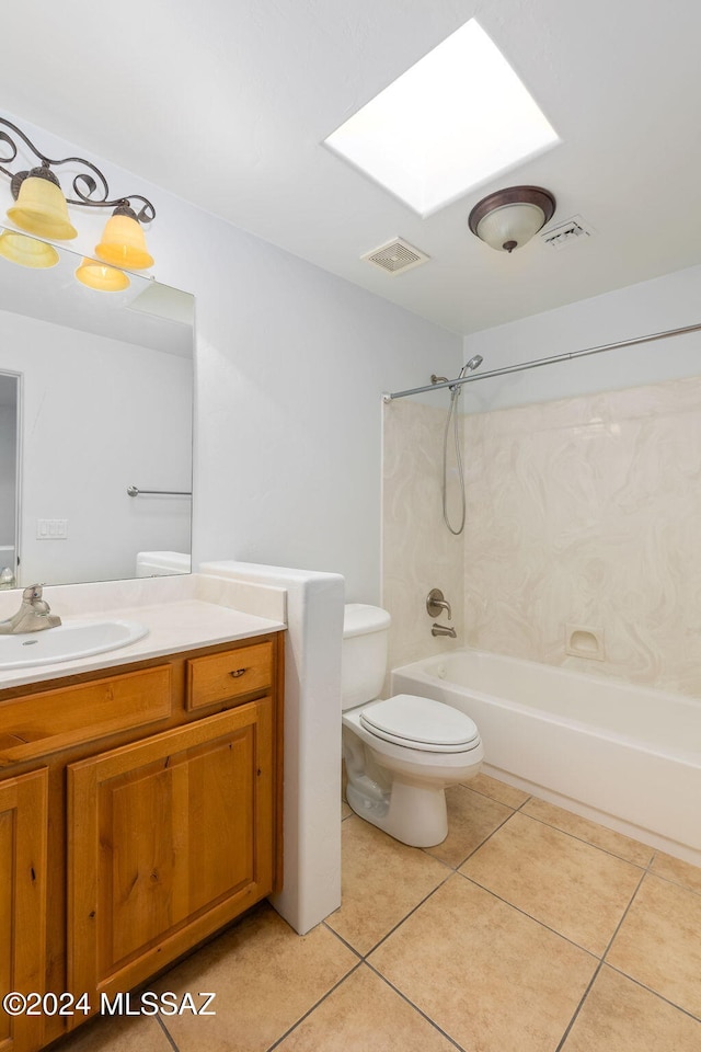 full bathroom with a skylight, tile patterned flooring, tub / shower combination, toilet, and vanity