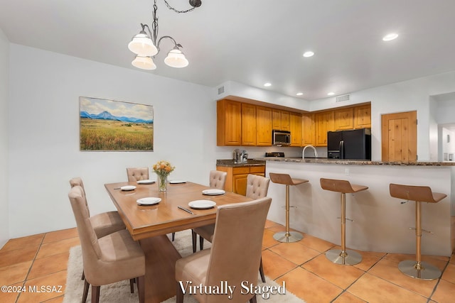 tiled dining space with an inviting chandelier