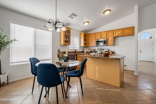 kitchen with pendant lighting, lofted ceiling, light tile patterned floors, a notable chandelier, and stainless steel appliances