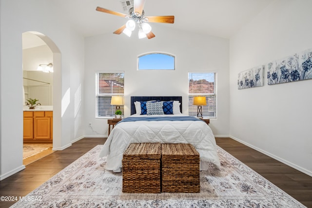 bedroom with ensuite bath, ceiling fan, dark hardwood / wood-style flooring, and lofted ceiling